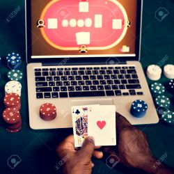 106300379 hand holding card playing online gambling 250